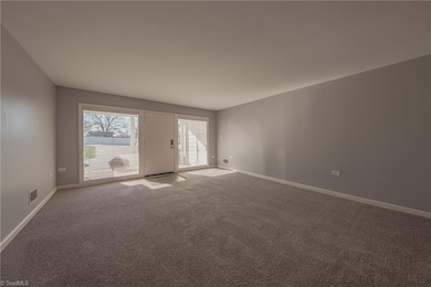 Living room to the back door and patio area.  Huge windows allow for tons of natural light.
