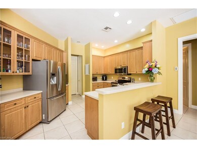 Spacious kitchen with stainless steel appliances and eat-in bar