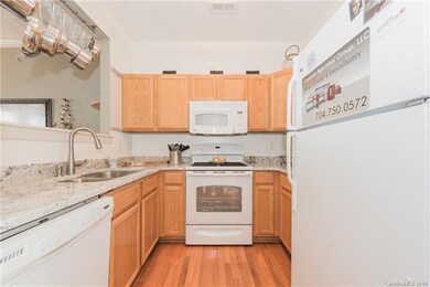 Galley kitchen with butcher block eat at bar makin