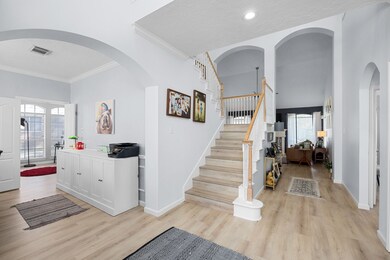 Step inside to a beautiful entry with soaring ceilings; formal dining to the left and an office behind French doors to the right.