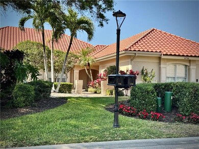 Mediterranean / spanish house with a front lawn, a tiled roof, and stucco siding