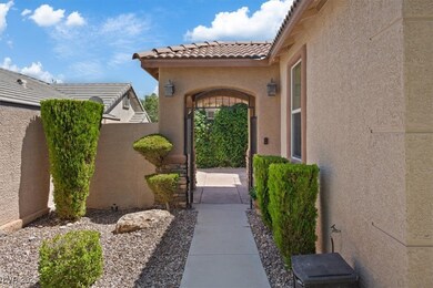 ENTER Courtyard entry arched gate, lush greenery,