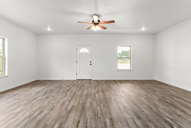 Foyer featuring baseboards, a ceiling fan, and wo