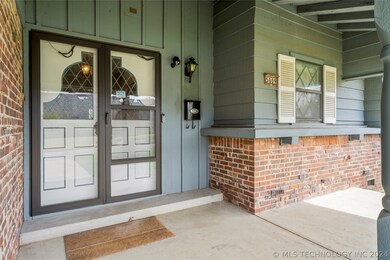 DOUBLE DOOR ENTRY ON LARGE COVERED FRONT PORCH