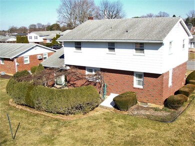 Elevated view of back showing manicured shrubs and