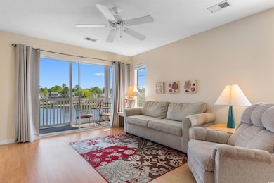 Living area with a water view, visible vents, ceil