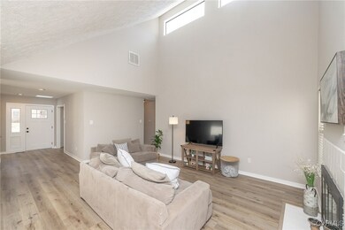 Living room with a healthy amount of sunlight, a b