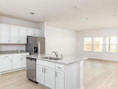 Kitchen featuring a sink, visible vents, light wo