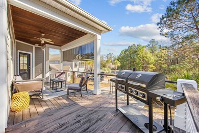 Wooden terrace with grilling area and ceiling fan