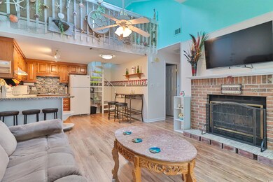Living room with ceiling fan, light wood-type floo