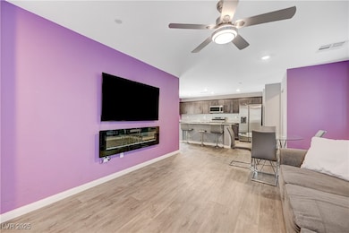 Living area featuring light wood-type flooring, ce