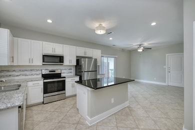 Kitchen featuring a sink, light tile patterned fl