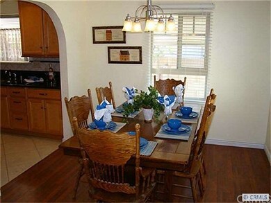 Dining area into kitchen also features arched deta
