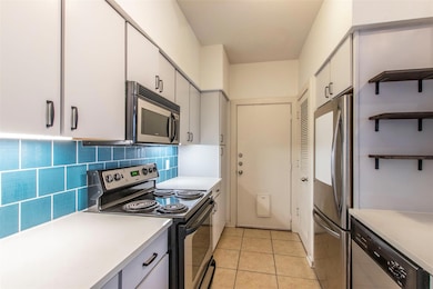 Kitchen with light tile patterned flooring, decor
