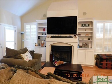 Fire place is flanked by windows for lots of natur