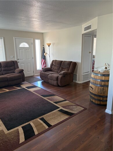 Living area featuring wood finished floors and a t