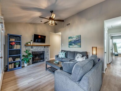Spacious living room with a peek down the hall int