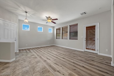 Empty room with a ceiling fan and baseboards