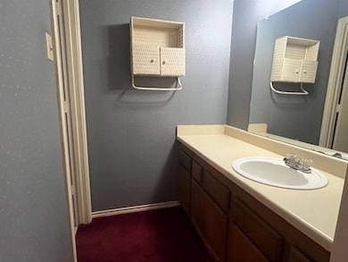 Bathroom featuring vanity and baseboards