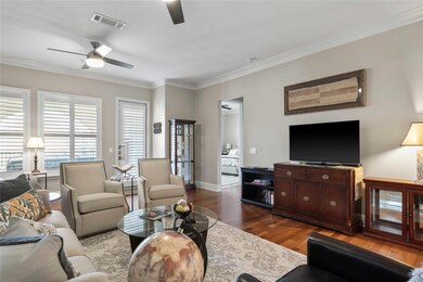 Living room featuring ceiling fan, dark hardwood /