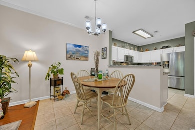 Dining area featuring a chandelier, light tile pat