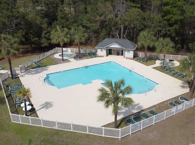 Pool with an outdoor structure, fence, a hot tub, 