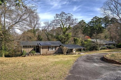 Ranch-style home featuring aphalt driveway, roof m