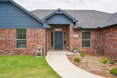 Property entrance featuring a shingled roof and br