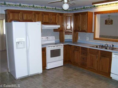 Kitchen. Kitchen inlcudes refrigerator and convenient pass thru to DR.