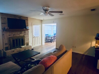 Living room featuring ceiling fan, wood finished f