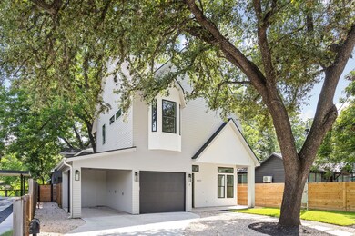 View of front facade featuring an attached garage and driveway