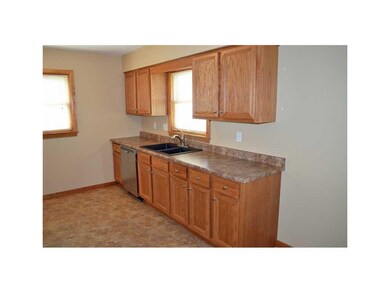 . Window above granite sink overlooks fenced-in ba