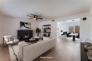 Living area with wood finished floors, a fireplace