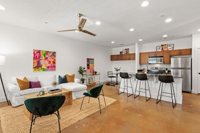 Living room with recessed lighting, concrete floo