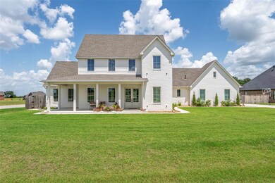 Back of house featuring a shingled roof, french doors, and brick siding