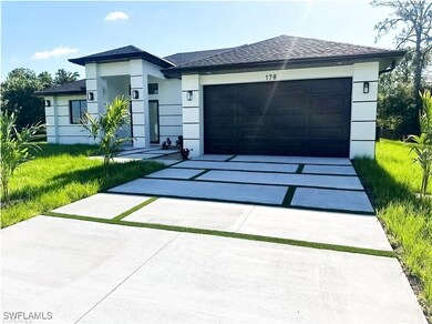 View of front of property with driveway, stucco si