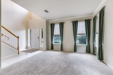 Tiled entryway with ornamental molding, carpet fl
