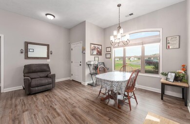 Dining space with a chandelier, wood finished floo