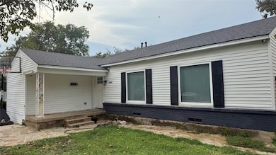 Back of property featuring roof with shingles, crawl space, and a lawn