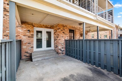 View of patio with french doors and a balcony
