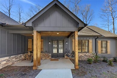 Relaxing covered porch area features rich wood ceiling, ideal for the included porch swing.