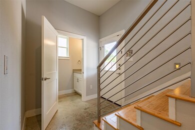 Stairs with baseboards and unfinished concrete fl