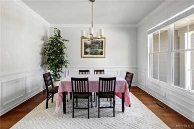 Formal dining room with crown moulding and wainsco