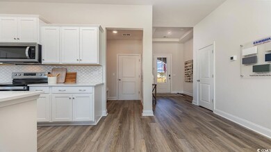 Kitchen featuring white cabinetry, visible vents, 