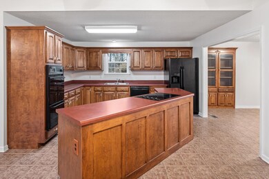 Open Kitchen with large island. All appliances convey with the property.