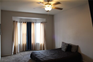 Bedroom with ceiling fan, multiple windows, carpet