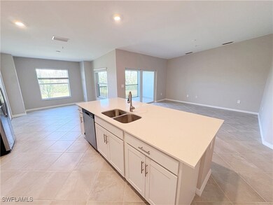 Kitchen featuring a sink, open floor plan, stainle