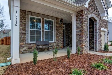 Covered front porch with beautiful stone work crea