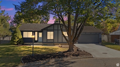 Tudor home with concrete driveway, roof with shingles, and a garage