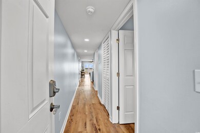 Hallway with light wood-type flooring